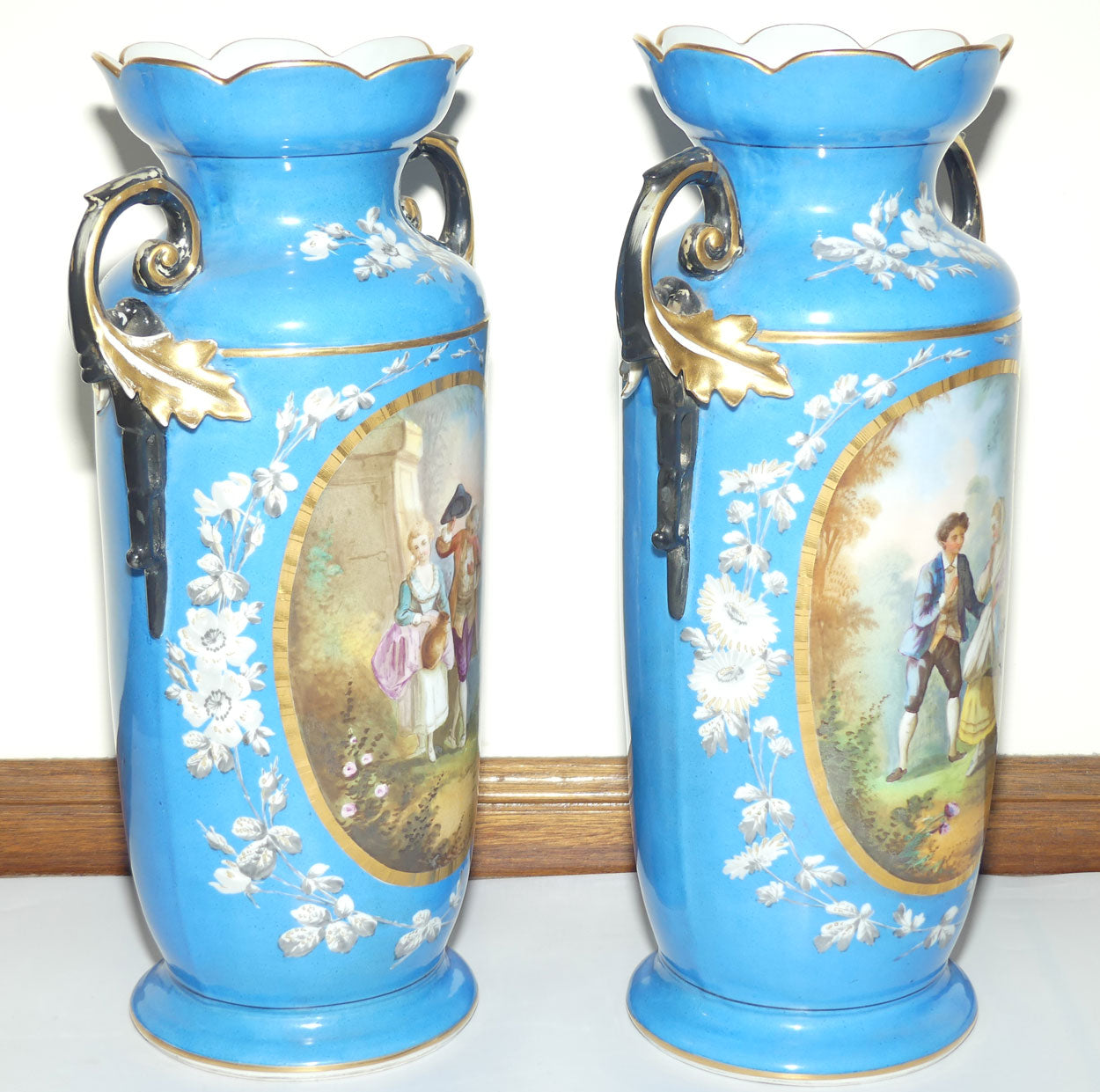 Pair of Continental European mantle vases with courting couple scenes c.1890