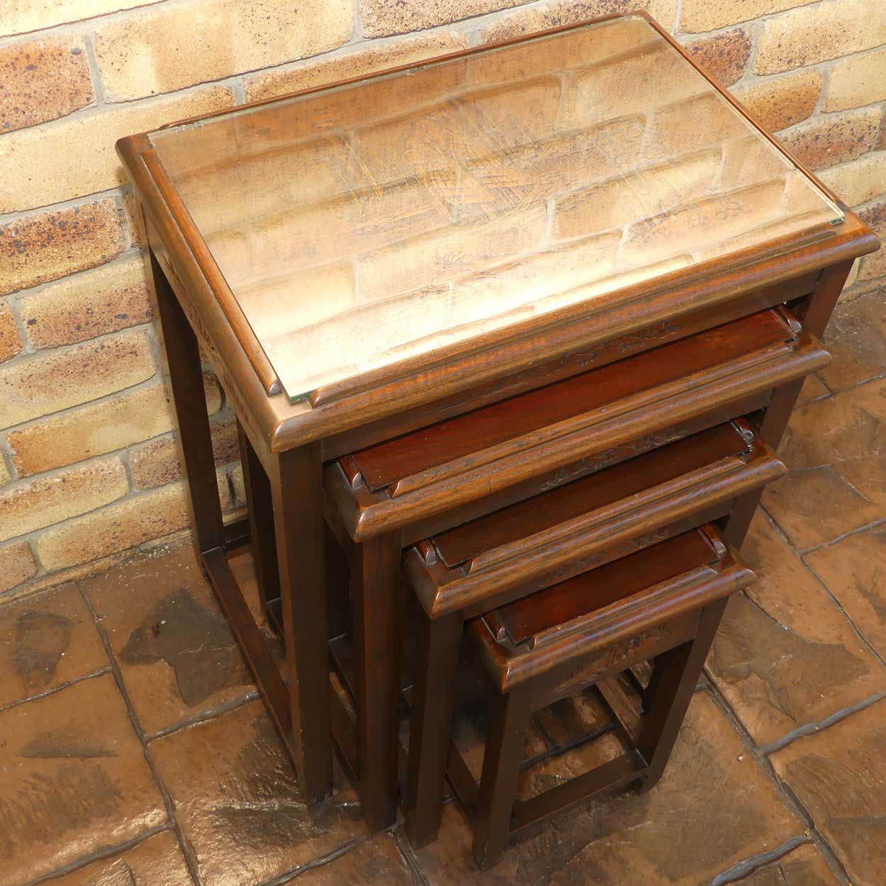 Chinese Carved Nest of 4 Occasional tables with Glass tops