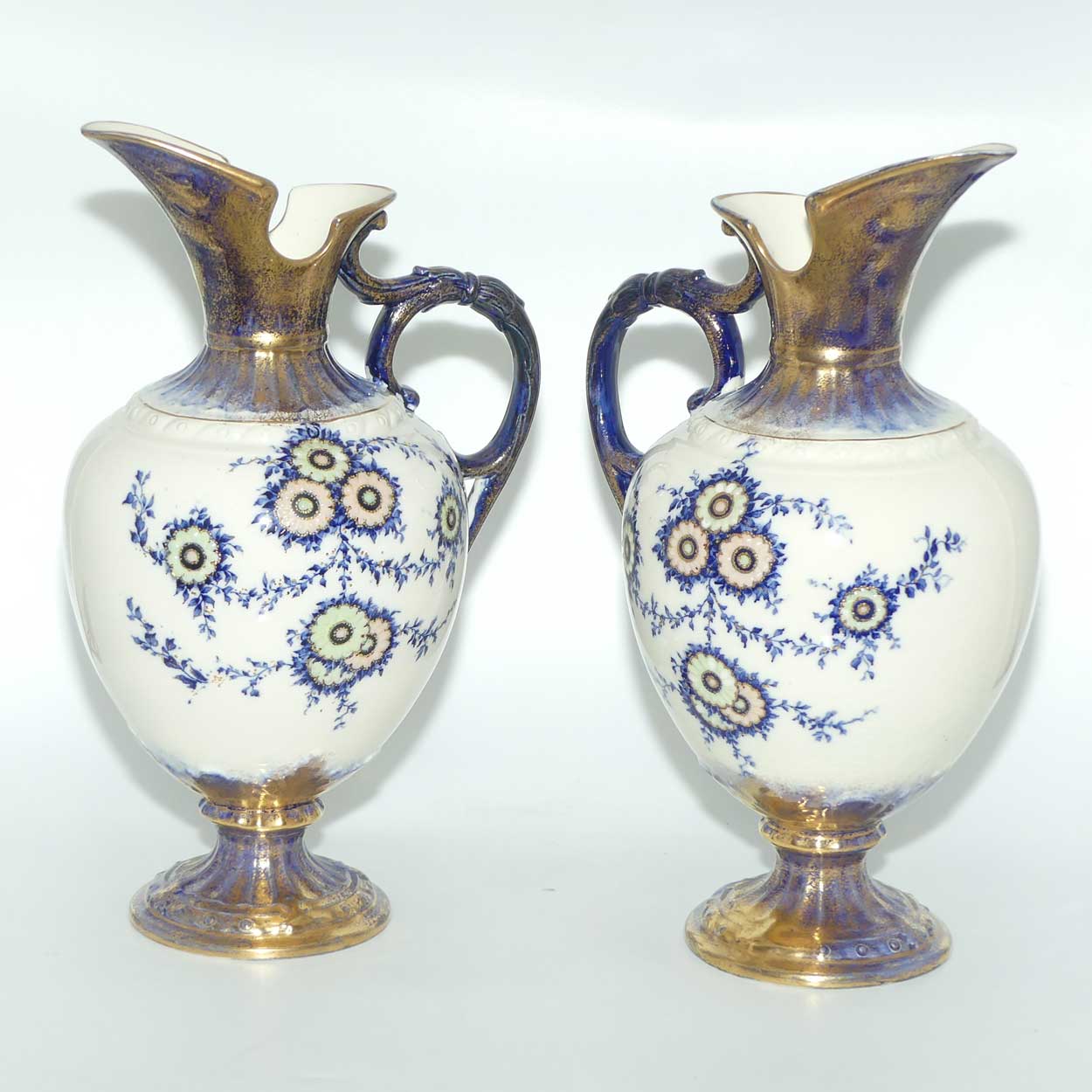 Pair of Flow Blue and Gilt Staffordshire floral decorated ewers