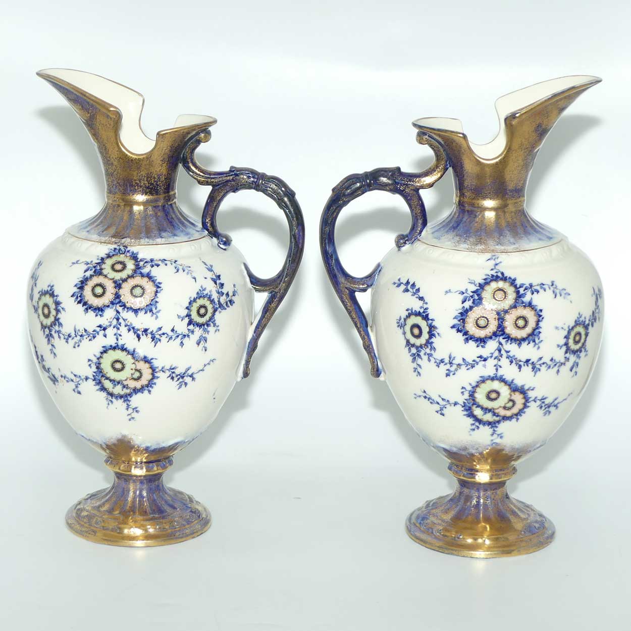 Pair of Flow Blue and Gilt Staffordshire floral decorated ewers