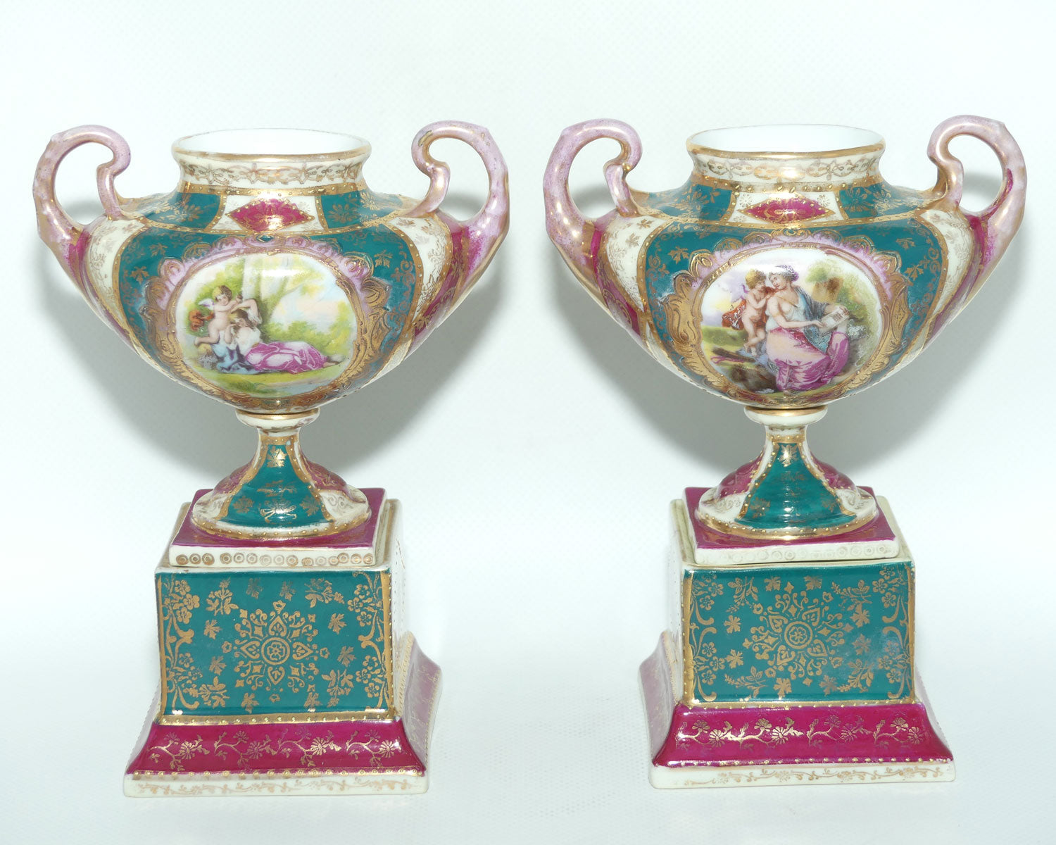 Royal Vienna pair of smaller twin handle cabinet vases on plinths