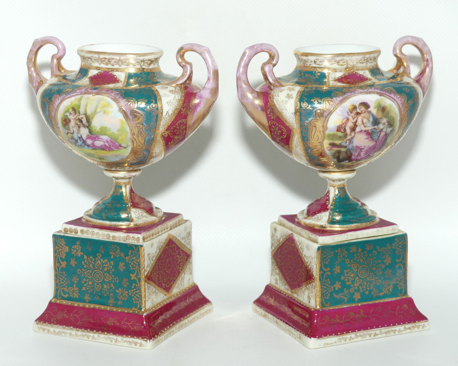Royal Vienna pair of smaller twin handle cabinet vases on plinths