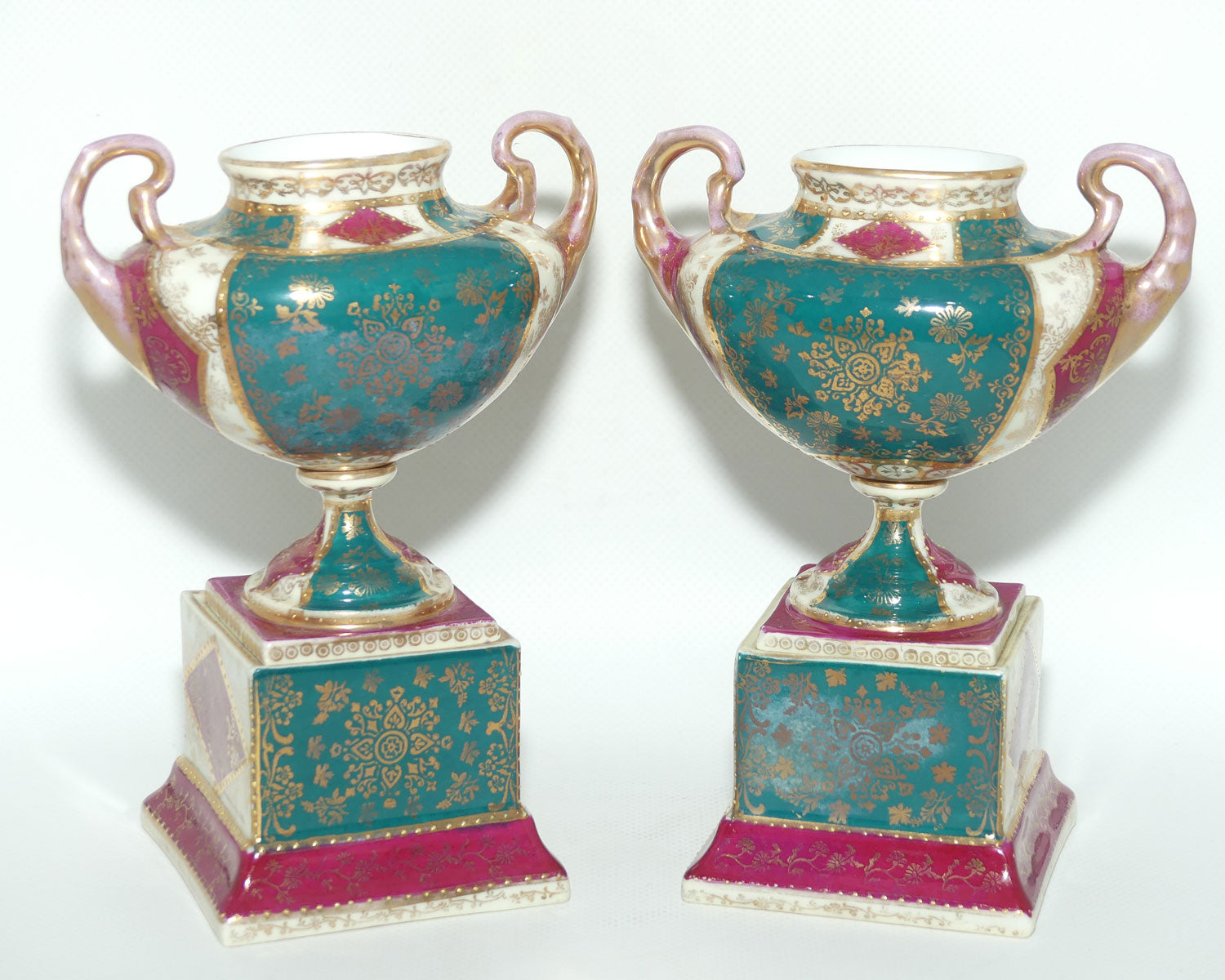 Royal Vienna pair of smaller twin handle cabinet vases on plinths