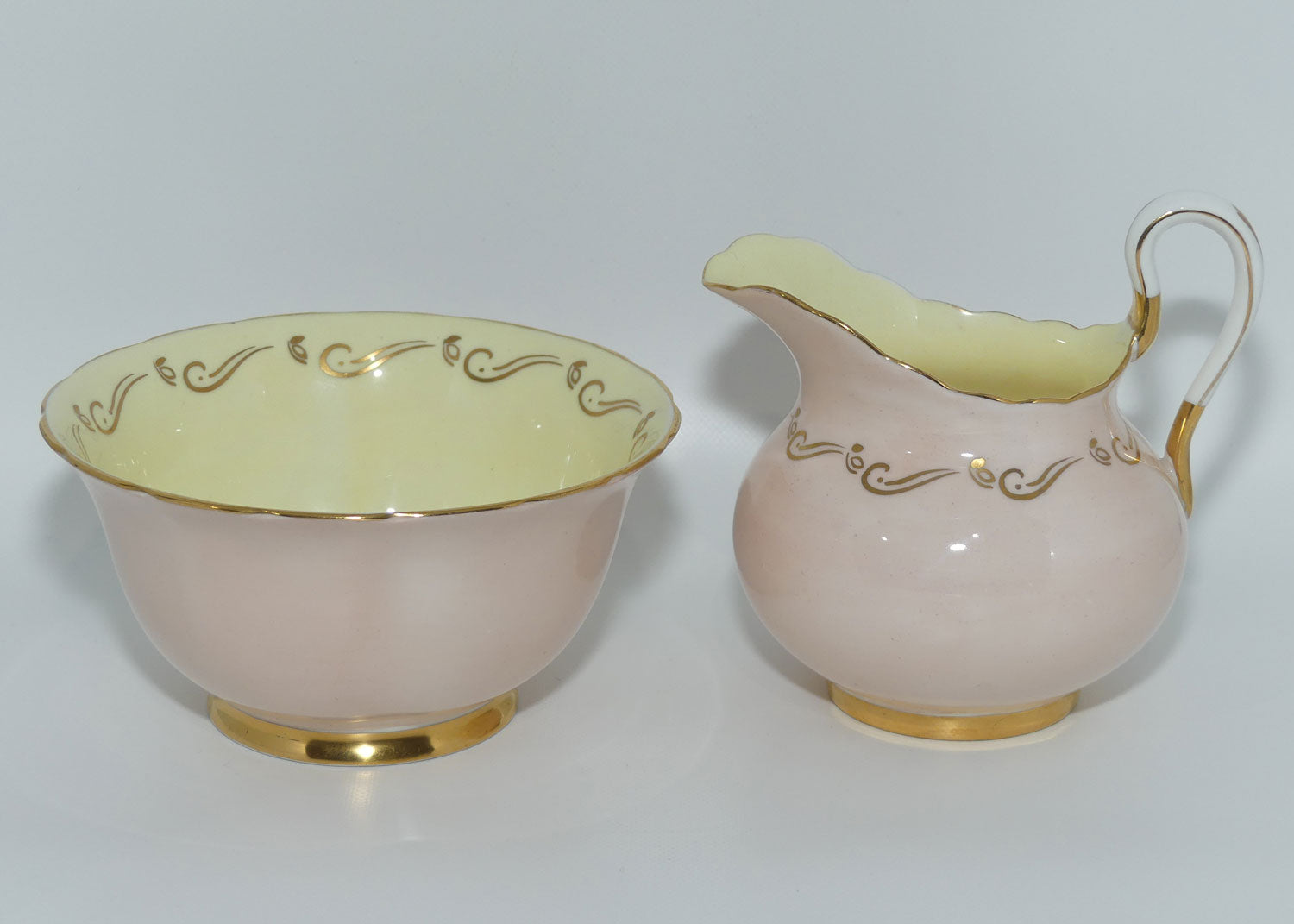 Tuscan Fine English Bone China Pink and Gilt Swirl milk and sugar | Fancy handle | Yellow Interior