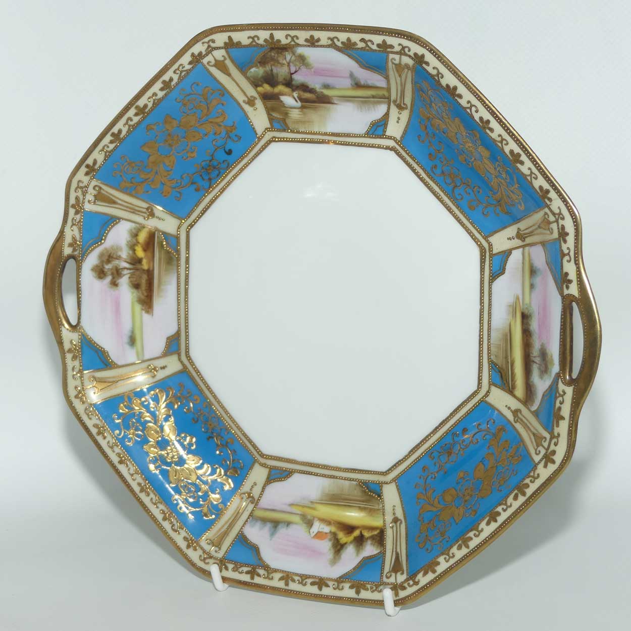 early Noritake Hand Painted and Gilt decorated Blue ground twin handle cake plate | Lake Scene