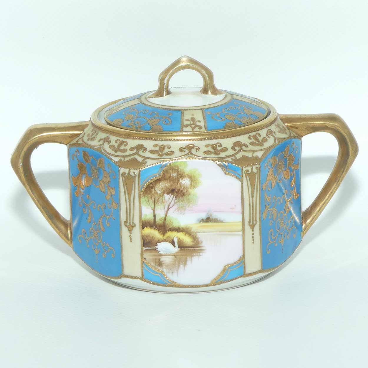 early Noritake Hand Painted and Gilt decorated Blue ground milk and sugar | Hexagonal shape | Lake Scene