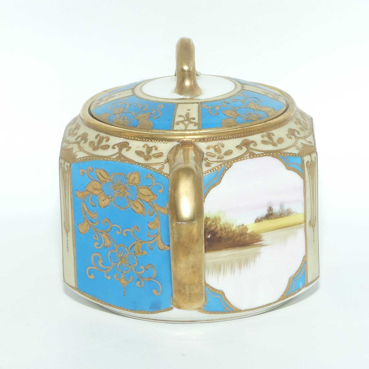 early Noritake Hand Painted and Gilt decorated Blue ground milk and sugar | Hexagonal shape | Lake Scene