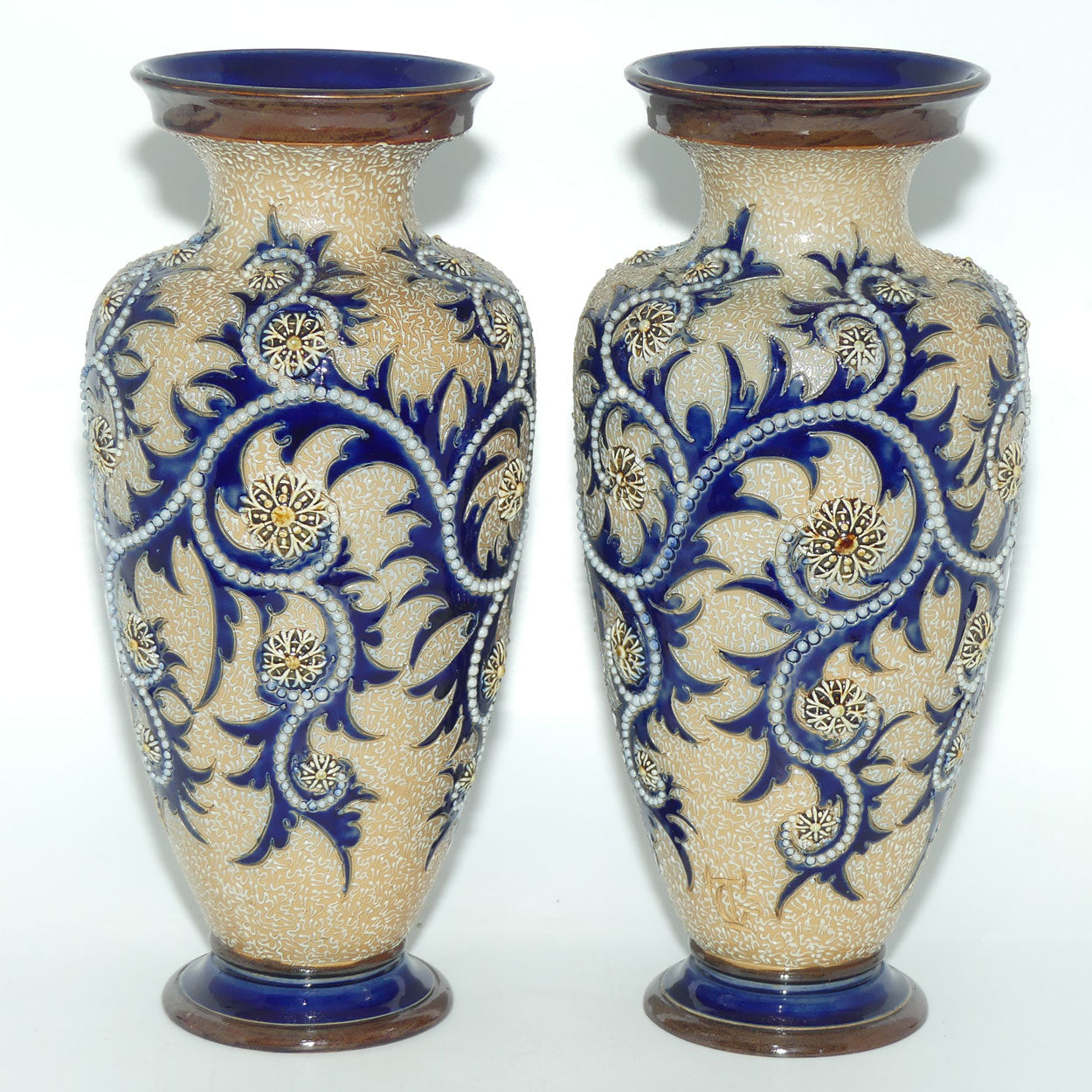 Royal Doulton stoneware George Tinworth pair of bulbous centrepiece vases with applied baguette beads and foliage