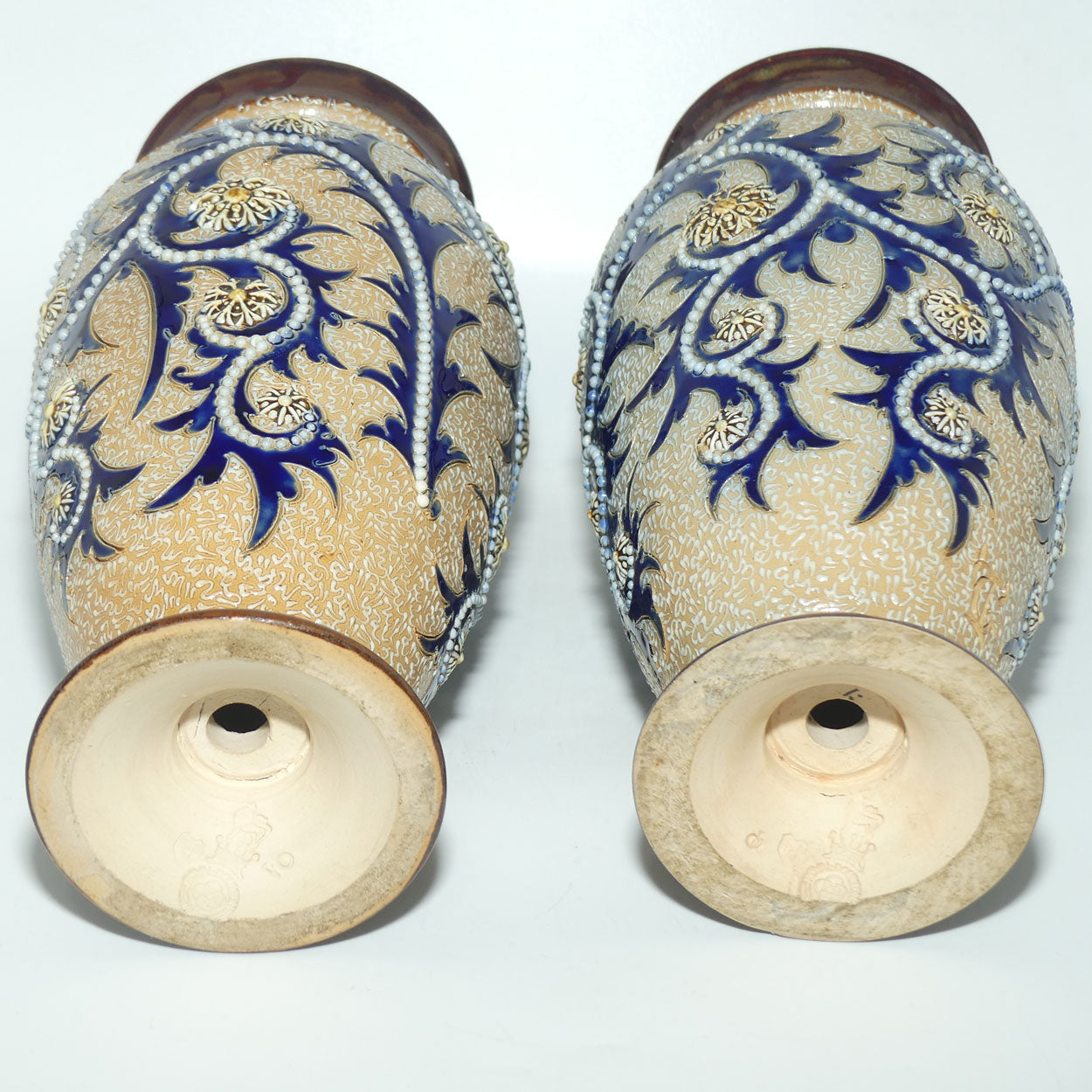Royal Doulton stoneware George Tinworth pair of bulbous centrepiece vases with applied baguette beads and foliage