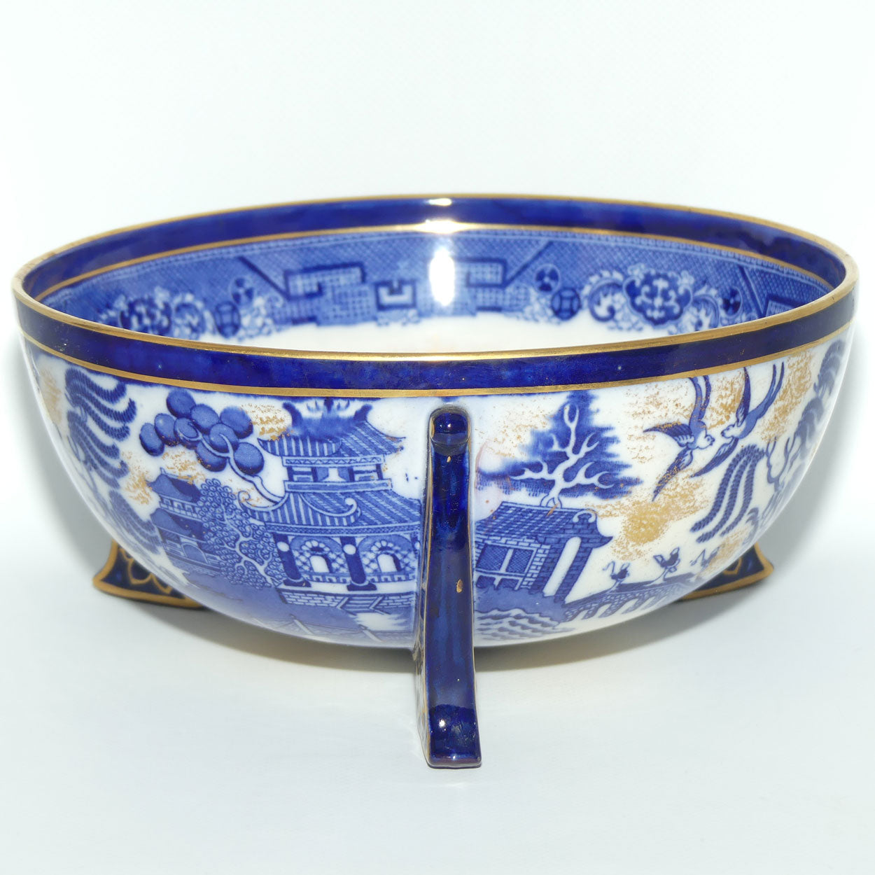 Doulton Burslem England Flow Blue Willow bowl on figured feet | unmarked