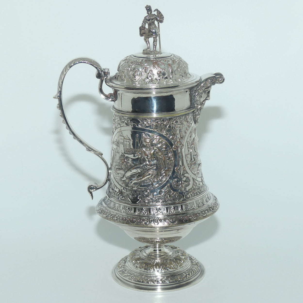 John Grinsell and Sons Silver Plate Heavily decorated Wine Jug with motto Patientia Solertia Nolvi