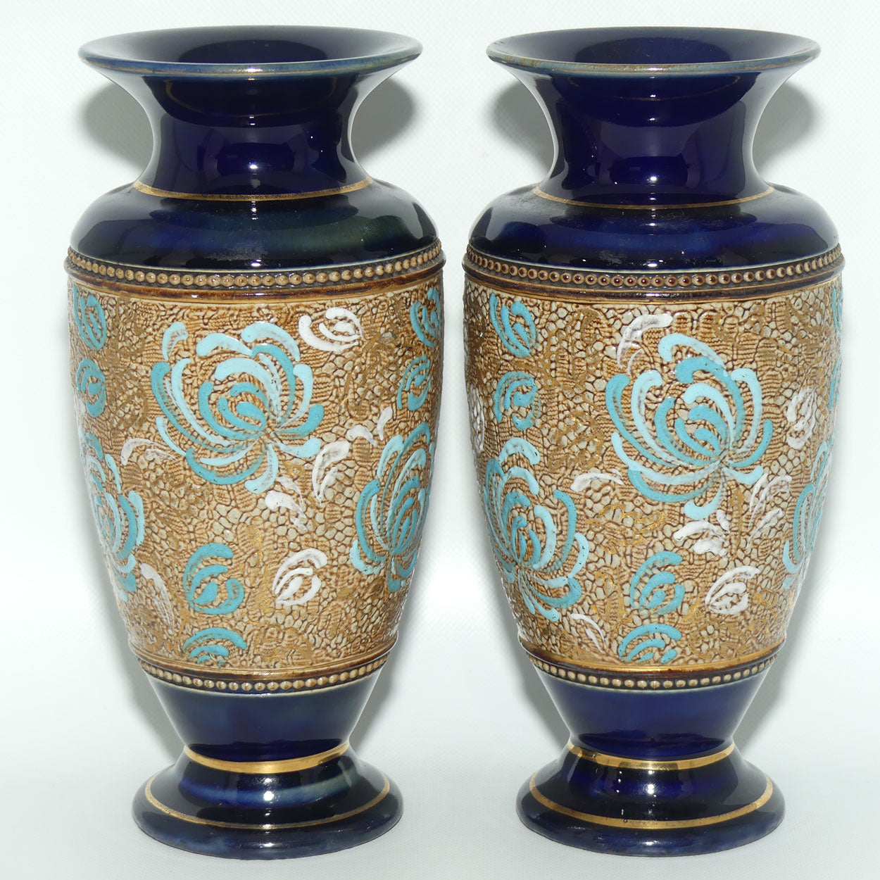 Royal Doulton pair of small stoneware vases with blue & white enamelled flowers & gilt highlights (X5564)