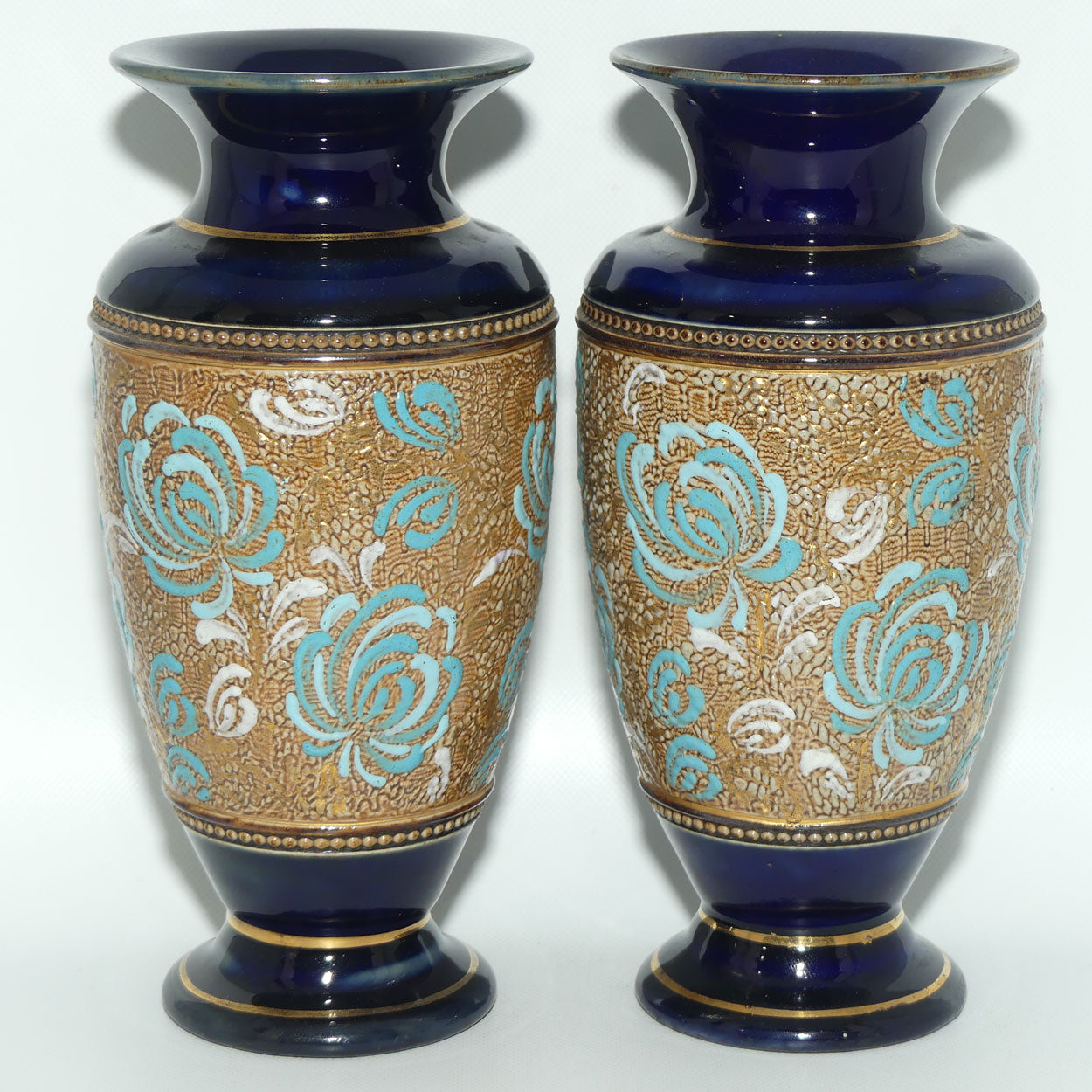 Royal Doulton pair of small stoneware vases with blue & white enamelled flowers & gilt highlights (X5564)